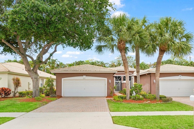5871 Grand Harbour Cir, Boynton Beach, FL 33437 - ranch-style house with stucco siding, driveway, a garage, a tile roof, and a front lawn