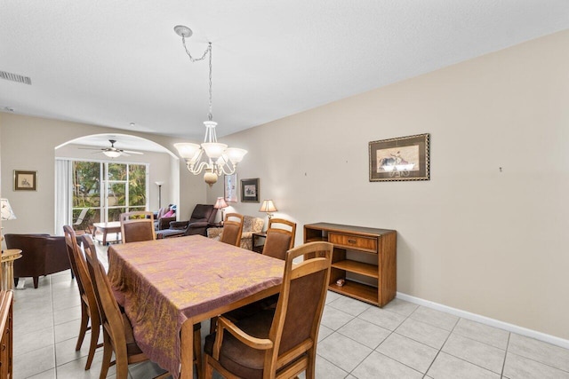 5871 Grand Harbour Cir, Boynton Beach, FL 33437 - dining space with arched walkways, a chandelier, light tile patterned flooring, and baseboards