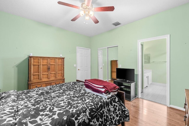 5871 Grand Harbour Cir, Boynton Beach, FL 33437 - bedroom featuring wood finished floors, baseboards, ceiling fan, and ensuite bath