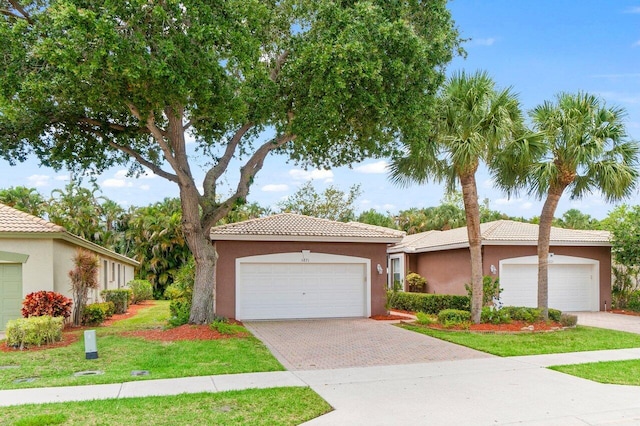 5871 Grand Harbour Cir, Boynton Beach, FL 33437 - view of front of property featuring stucco siding, a tiled roof, a front lawn, and driveway
