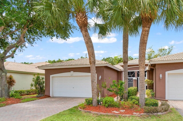 5871 Grand Harbour Cir, Boynton Beach, FL 33437 - view of front of home with stucco siding, decorative driveway, a garage, and a tiled roof