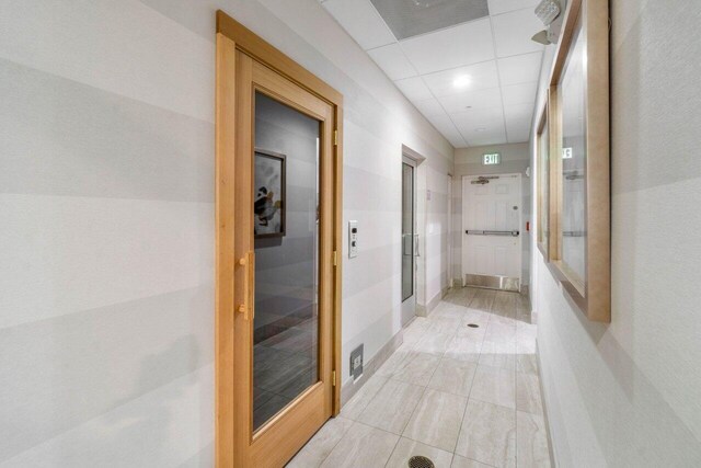 5871 Grand Harbour Cir, Boynton Beach, FL 33437 - corridor featuring light tile patterned floors and a drop ceiling