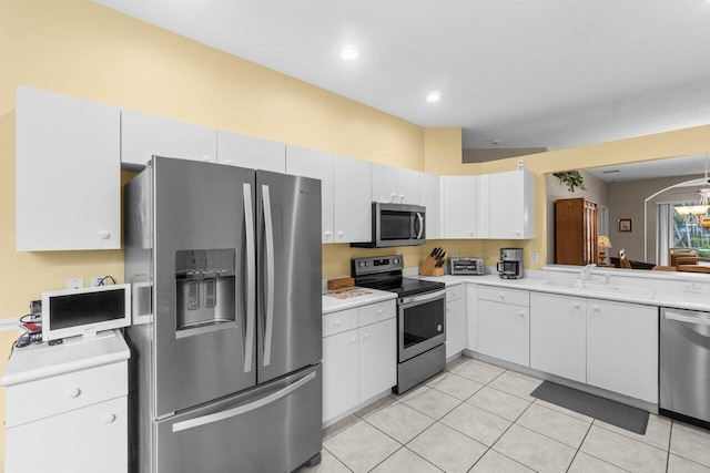5871 Grand Harbour Cir, Boynton Beach, FL 33437 - kitchen with stainless steel appliances, light countertops, light tile patterned floors, white cabinetry, and a sink