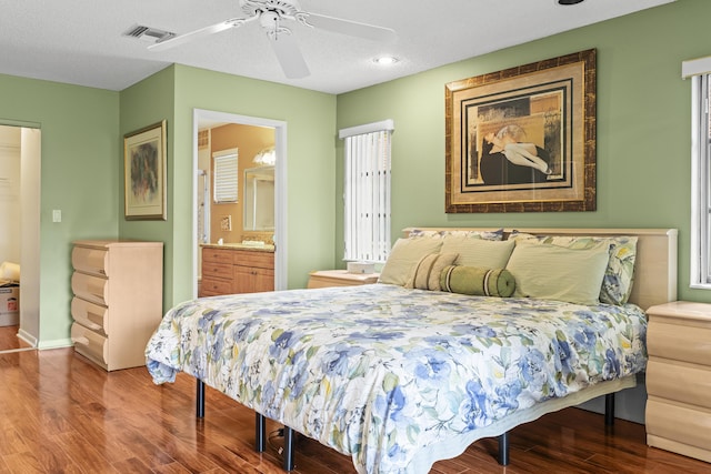 6067 Kings Gate Cir, Delray Beach, FL 33484 - bedroom featuring wood finished floors, a ceiling fan, connected bathroom, and baseboards
