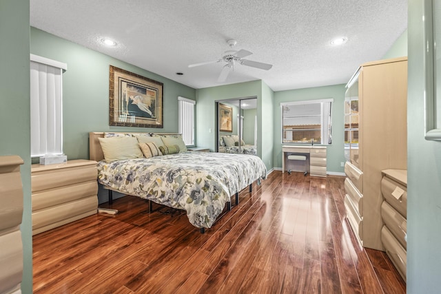 6067 Kings Gate Cir, Delray Beach, FL 33484 - bedroom featuring a textured ceiling, wood finished floors, ceiling fan, recessed lighting, and baseboards