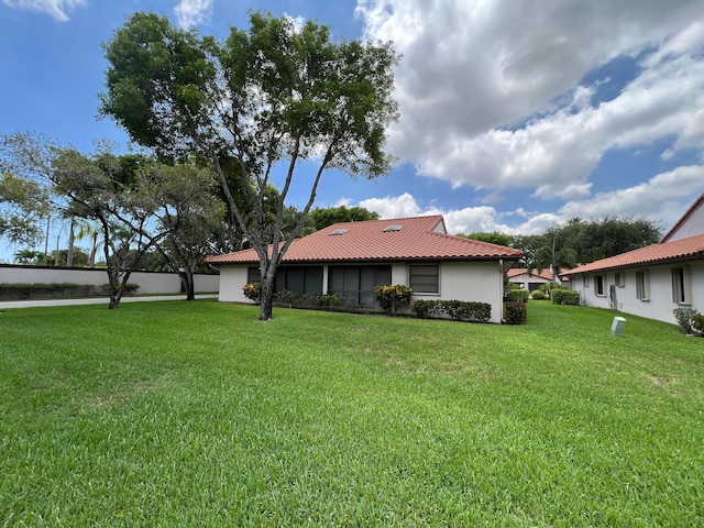 6067 Kings Gate Cir, Delray Beach, FL 33484 - rear view of house with stucco siding, a tiled roof, and a yard