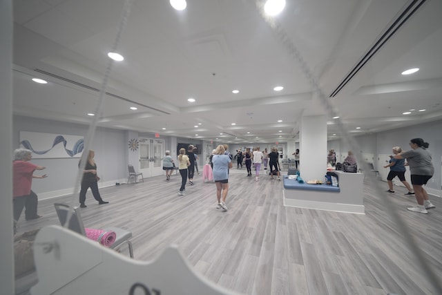 6067 Kings Gate Cir, Delray Beach, FL 33484 - exercise room featuring baseboards, light wood-style floors, and recessed lighting