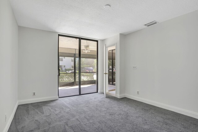 4733 NW 22nd St Unit 4283, Coconut Creek, FL 33063 - unfurnished room with expansive windows, carpet flooring, a textured ceiling, and baseboards