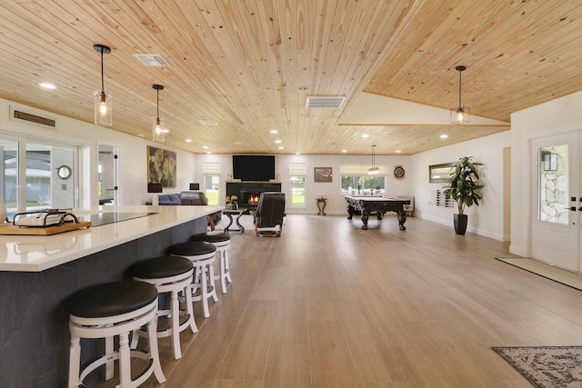 386 NE Ficus Ter, Jensen Beach, FL 34957 - kitchen with wooden ceiling, light wood-style flooring, billiards table, recessed lighting, and a warm lit fireplace