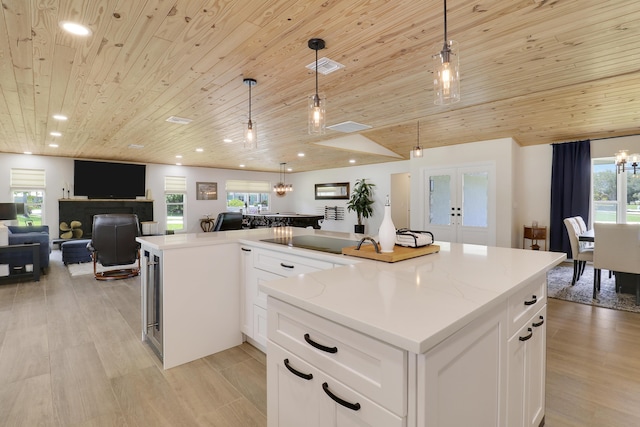 386 NE Ficus Ter, Jensen Beach, FL 34957 - kitchen featuring open floor plan, wooden ceiling, a large island, hanging light fixtures, and plenty of natural light