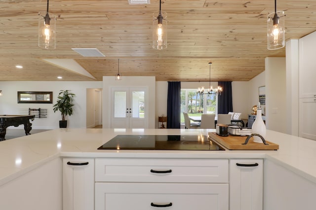 386 NE Ficus Ter, Jensen Beach, FL 34957 - kitchen with wood ceiling, black electric cooktop, white cabinets, french doors, and vaulted ceiling