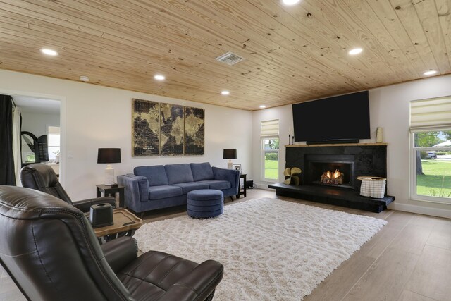 386 NE Ficus Ter, Jensen Beach, FL 34957 - living area with wooden ceiling, recessed lighting, light wood-type flooring, a lit fireplace, and baseboards