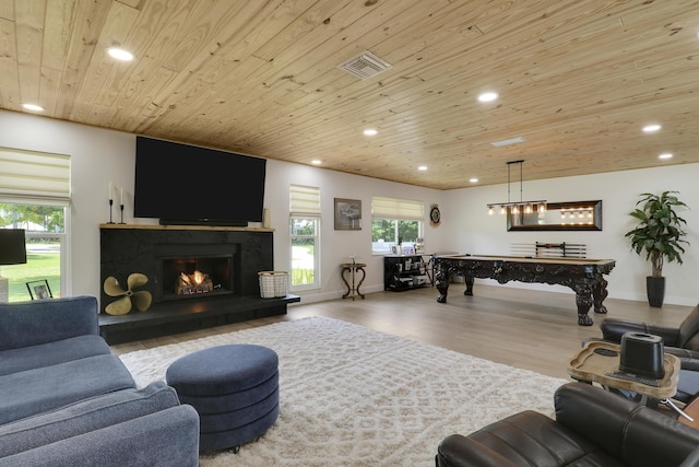 386 NE Ficus Ter, Jensen Beach, FL 34957 - living room featuring wooden ceiling, recessed lighting, wood finished floors, billiards, and a lit fireplace