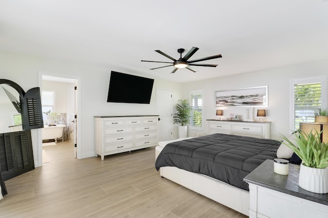 386 NE Ficus Ter, Jensen Beach, FL 34957 - bedroom featuring light wood-style flooring, a ceiling fan, and connected bathroom
