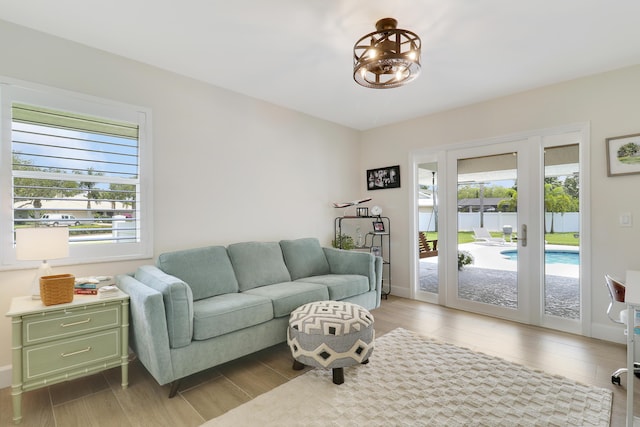 386 NE Ficus Ter, Jensen Beach, FL 34957 - living area featuring wood finished floors and a chandelier