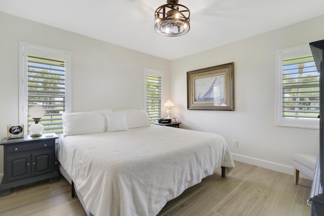 386 NE Ficus Ter, Jensen Beach, FL 34957 - bedroom featuring light wood-style floors and baseboards