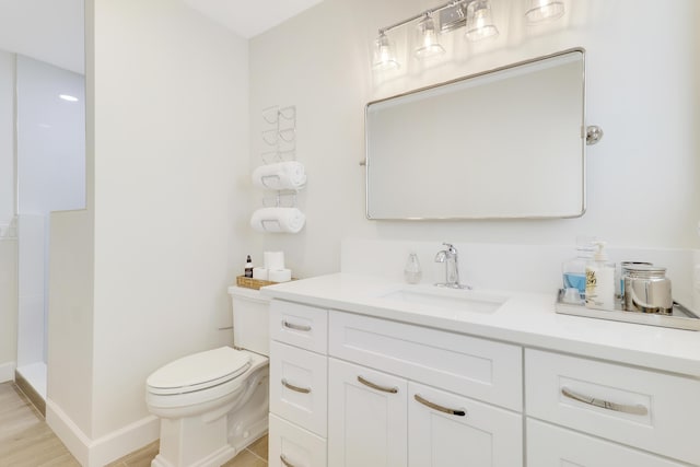 386 NE Ficus Ter, Jensen Beach, FL 34957 - bathroom with vanity, toilet, and baseboards