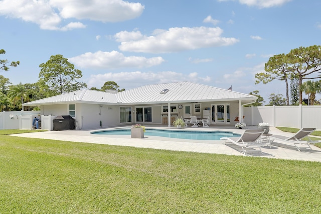 386 NE Ficus Ter, Jensen Beach, FL 34957 - back of property with a patio area, metal roof, and stucco siding