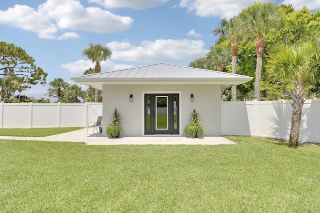 386 NE Ficus Ter, Jensen Beach, FL 34957 - rear view of property featuring stucco siding, a patio, a standing seam roof, and metal roof