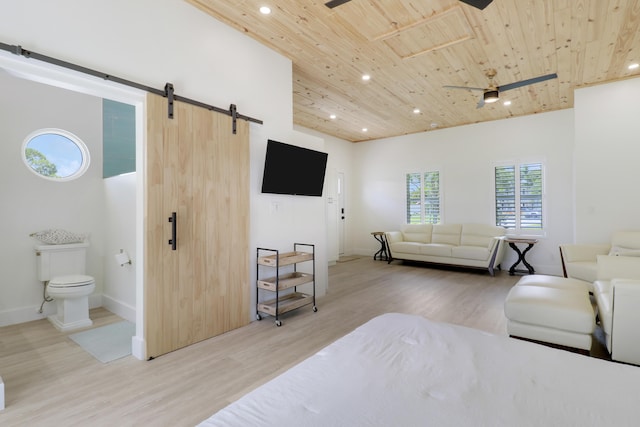 386 NE Ficus Ter, Jensen Beach, FL 34957 - living area featuring a barn door, wood ceiling, recessed lighting, wood finished floors, and baseboards