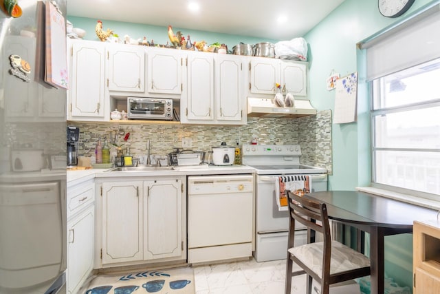7300 NW 5th Pl Unit 203, Margate, FL 33063 - kitchen with white appliances, under cabinet range hood, light marble finish flooring, a sink, and light countertops