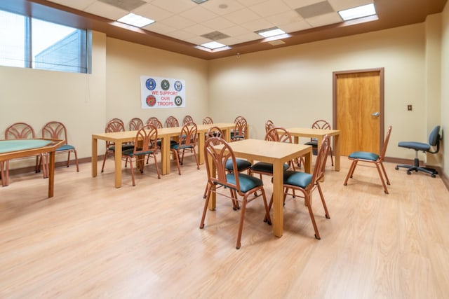 7300 NW 5th Pl Unit 203, Margate, FL 33063 - dining room featuring light wood-style floors, a paneled ceiling, and baseboards