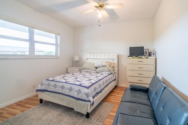 7300 NW 5th Pl Unit 203, Margate, FL 33063 - bedroom with light wood-style flooring, a ceiling fan, and baseboards