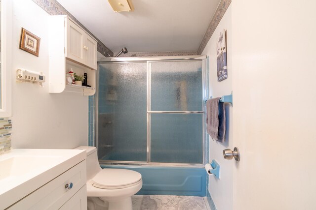 7300 NW 5th Pl Unit 203, Margate, FL 33063 - full bath with vanity, toilet, marble finish floors, combined bath / shower with glass door, and tasteful backsplash