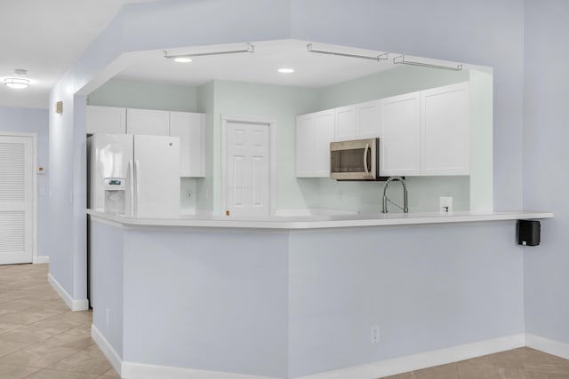 10125 N Military Trl, Palm Beach Gardens, FL 33410 - kitchen featuring white fridge with ice dispenser, stainless steel microwave, white cabinetry, light countertops, and recessed lighting