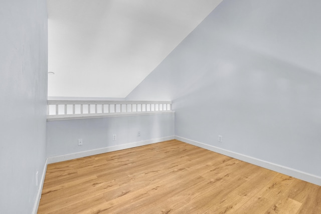 10125 N Military Trl, Palm Beach Gardens, FL 33410 - empty room with baseboards, wood finished floors, and vaulted ceiling