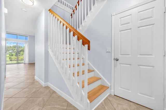 10125 N Military Trl, Palm Beach Gardens, FL 33410 - stairway featuring tile patterned flooring and baseboards
