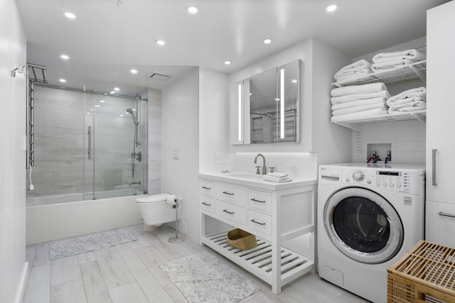 2301 Collins Ave Unit 1239, Miami Beach, FL 33139 - washroom featuring washer / dryer, recessed lighting, and light wood-style floors