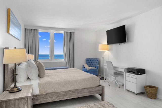 2301 Collins Ave Unit 1239, Miami Beach, FL 33139 - bedroom featuring multiple windows, baseboards, and light wood finished floors
