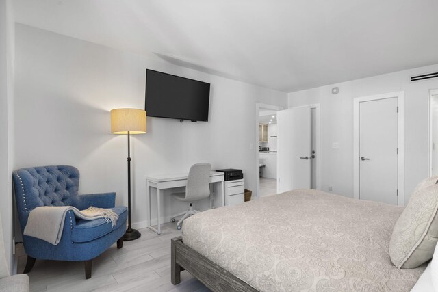 2301 Collins Ave Unit 1239, Miami Beach, FL 33139 - bedroom featuring light wood-style flooring, a desk, and baseboards