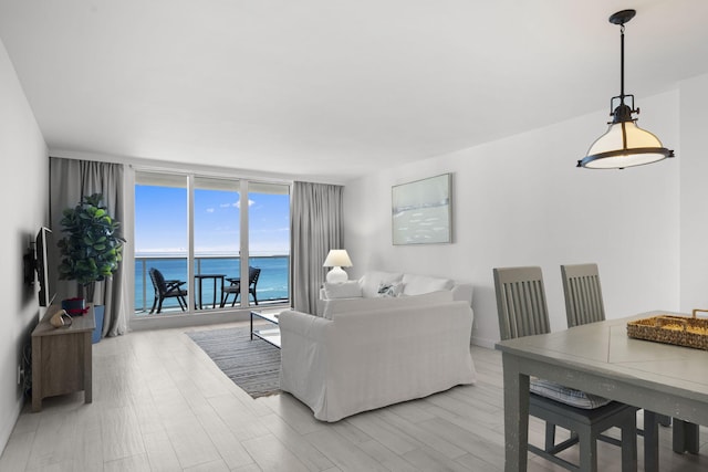 2301 Collins Ave Unit 1239, Miami Beach, FL 33139 - living area with expansive windows and light wood-style floors