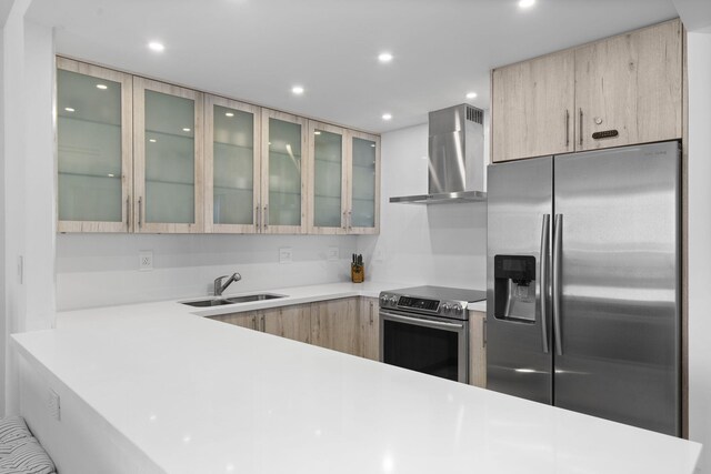 2301 Collins Ave Unit 1239, Miami Beach, FL 33139 - kitchen with appliances with stainless steel finishes, wall chimney exhaust hood, a sink, light countertops, and recessed lighting