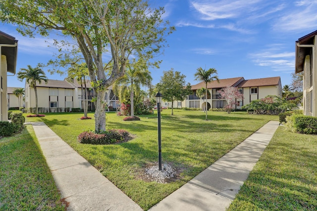 3561 Tall Pine Way Unit B-1, Greenacres, FL 33463 - surrounding community featuring a residential view and a lawn