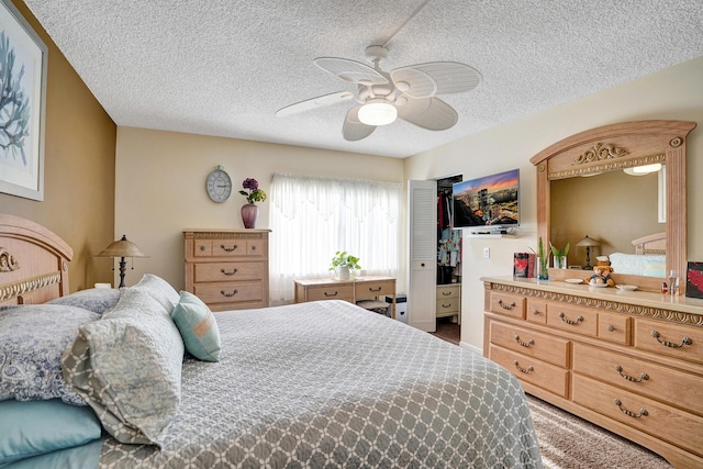 3561 Tall Pine Way Unit B-1, Greenacres, FL 33463 - bedroom featuring a textured ceiling, ceiling fan, a closet, and carpet floors