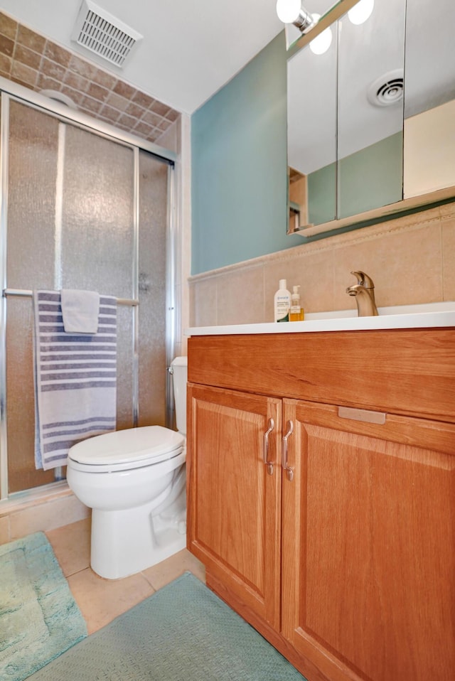3561 Tall Pine Way Unit B-1, Greenacres, FL 33463 - bathroom featuring toilet, vanity, a shower stall, tile walls, and tile patterned floors