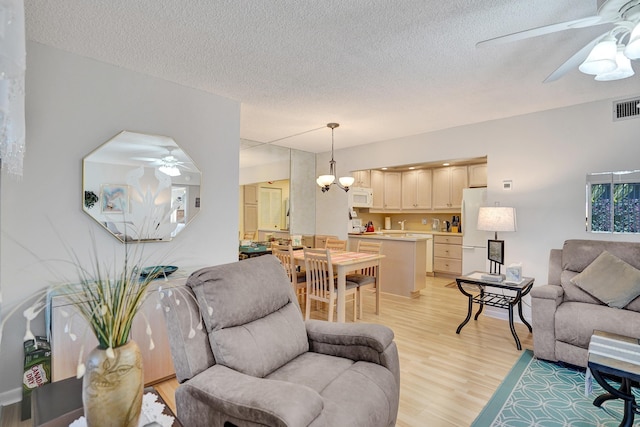 3561 Tall Pine Way Unit B-1, Greenacres, FL 33463 - living area with ceiling fan, light wood-type flooring, and a textured ceiling