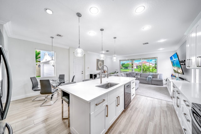 1855 SW Jamesport Dr, Port Saint Lucie, FL 34953 - kitchen featuring a sink, light countertops, ornamental molding, recessed lighting, and stainless steel appliances