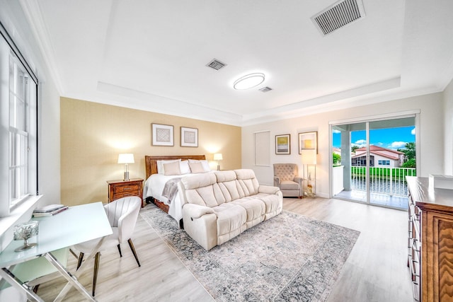 1855 SW Jamesport Dr, Port Saint Lucie, FL 34953 - bedroom featuring a raised ceiling, access to exterior, and wood finished floors