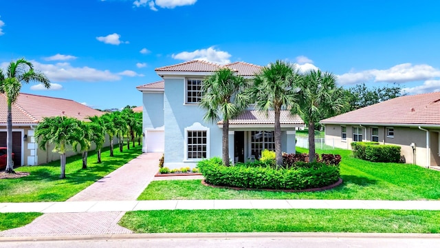 1855 SW Jamesport Dr, Port Saint Lucie, FL 34953 - mediterranean / spanish house featuring a tiled roof, stucco siding, and driveway
