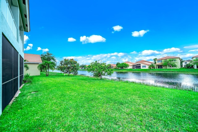 1855 SW Jamesport Dr, Port Saint Lucie, FL 34953 - view of green lawn featuring a water view