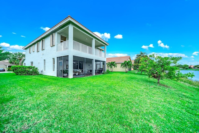 1855 SW Jamesport Dr, Port Saint Lucie, FL 34953 - rear view of property featuring a balcony, a yard, and stucco siding