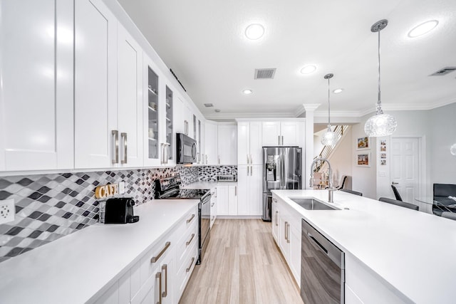 1855 SW Jamesport Dr, Port Saint Lucie, FL 34953 - kitchen featuring black appliances, a sink, light countertops, glass insert cabinets, and decorative light fixtures