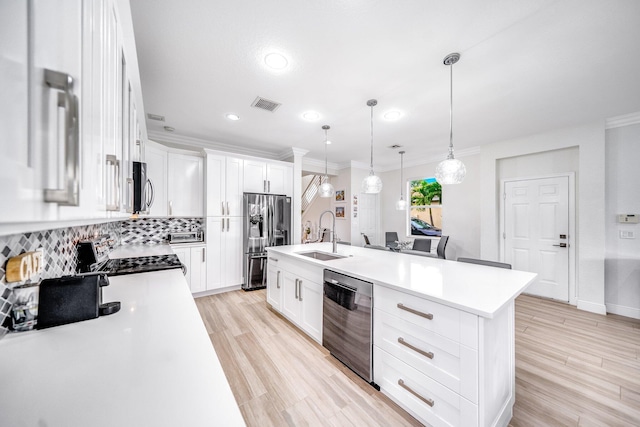 1855 SW Jamesport Dr, Port Saint Lucie, FL 34953 - kitchen with appliances with stainless steel finishes, a sink, decorative backsplash, ornamental molding, and light countertops