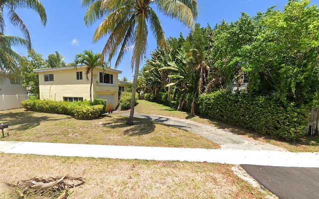 475 NE 14th St, Boca Raton, FL 33432 - view of yard with an attached garage and driveway