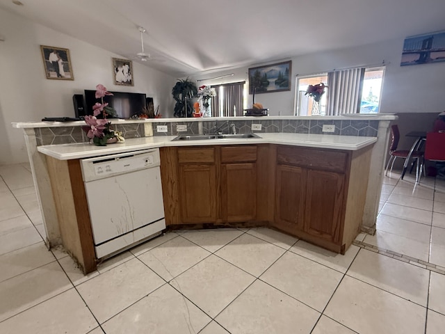 416 SE Calmoso Dr, Port Saint Lucie, FL 34983 - kitchen featuring dishwasher, a sink, brown cabinets, and light countertops