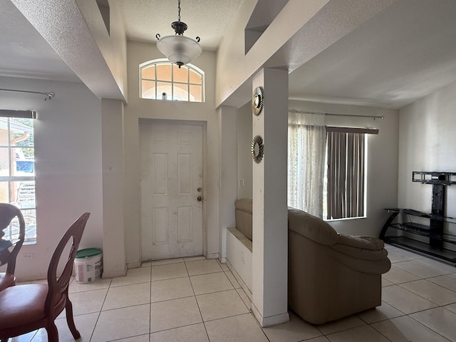 416 SE Calmoso Dr, Port Saint Lucie, FL 34983 - entrance foyer featuring healthy amount of natural light, a textured ceiling, and light tile patterned floors